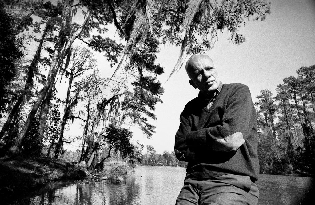 Walker Percy on the dock at Bogue Falaya at the family home in Covington, La.