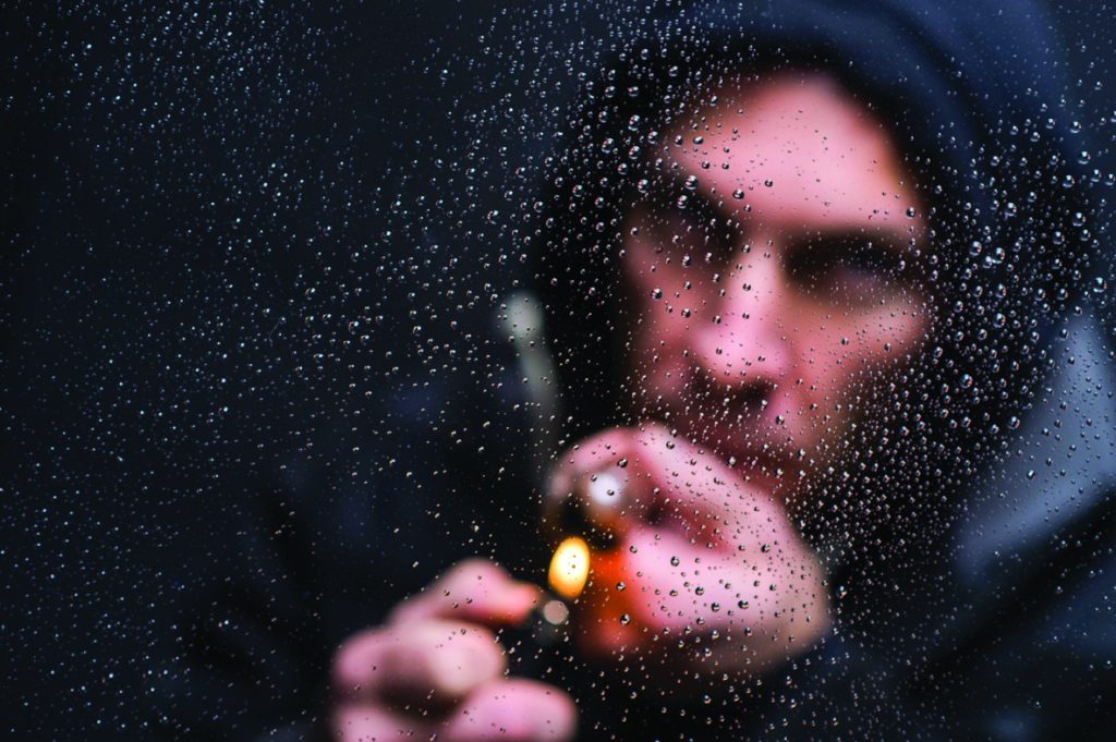 Drug Addiction photo illustration of model smoking a crack pipe.