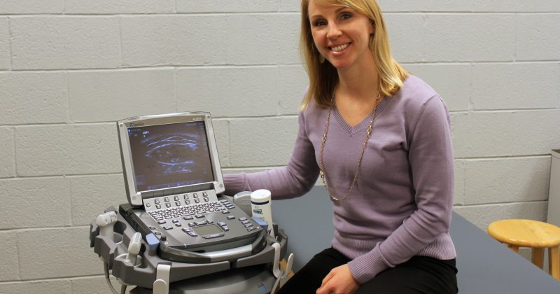Becky Begalle next to an ultrasound machine