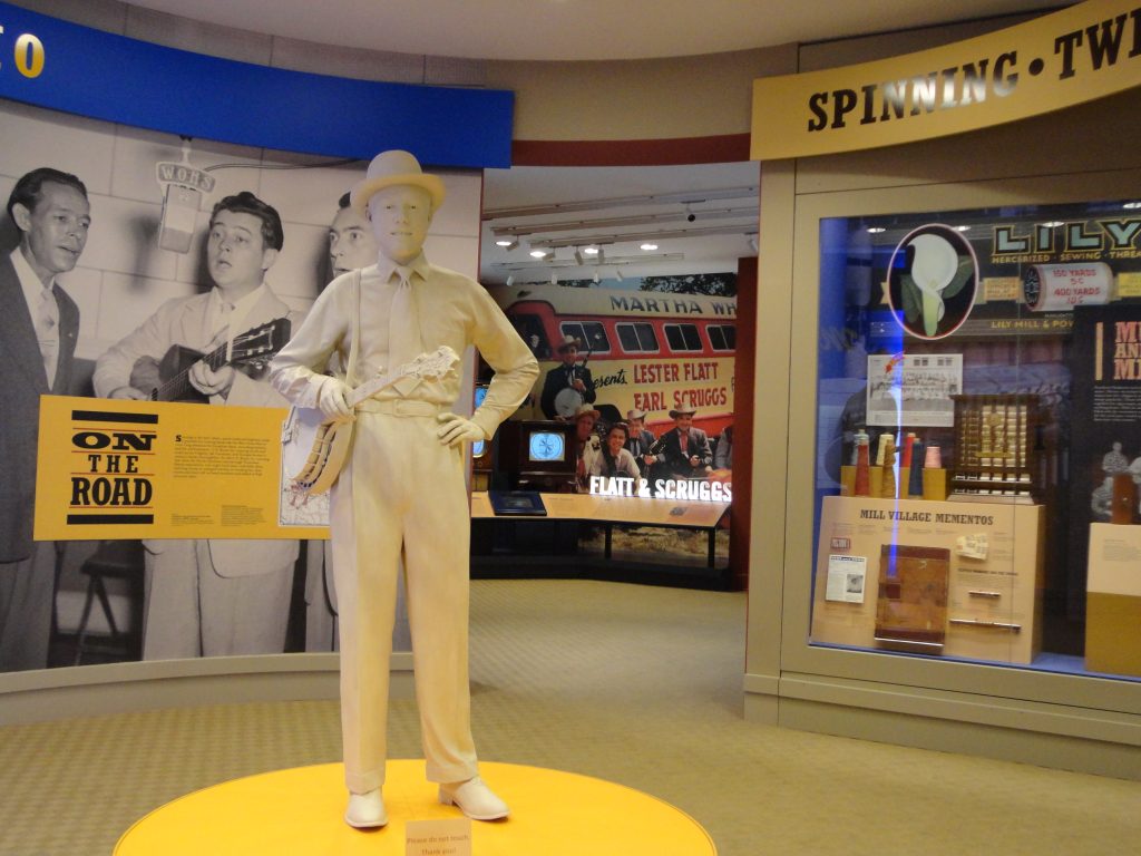 A statue of Earl Scruggs greets visitors at the entrance of the Earl Scruggs Museum