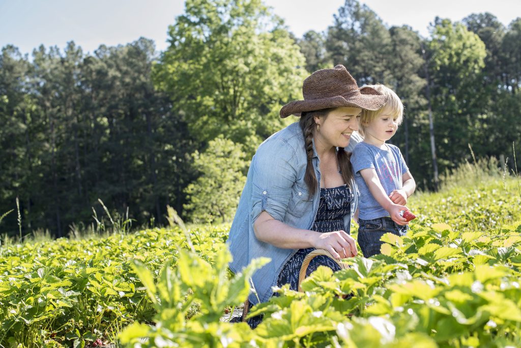 April McGreger and her son in a strawberry field