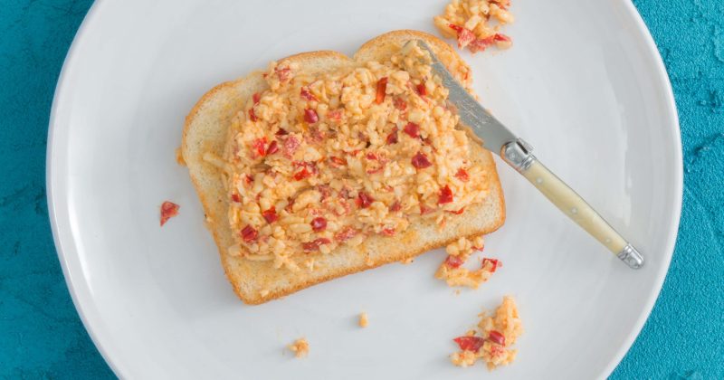 A plate of pimento cheese spread on a piece of bread