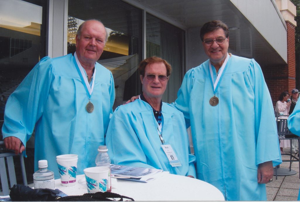 Joe Quigg, Bob Young and Lennie Rosenbluth wear Carolina blue graduation gowns at a reunion event