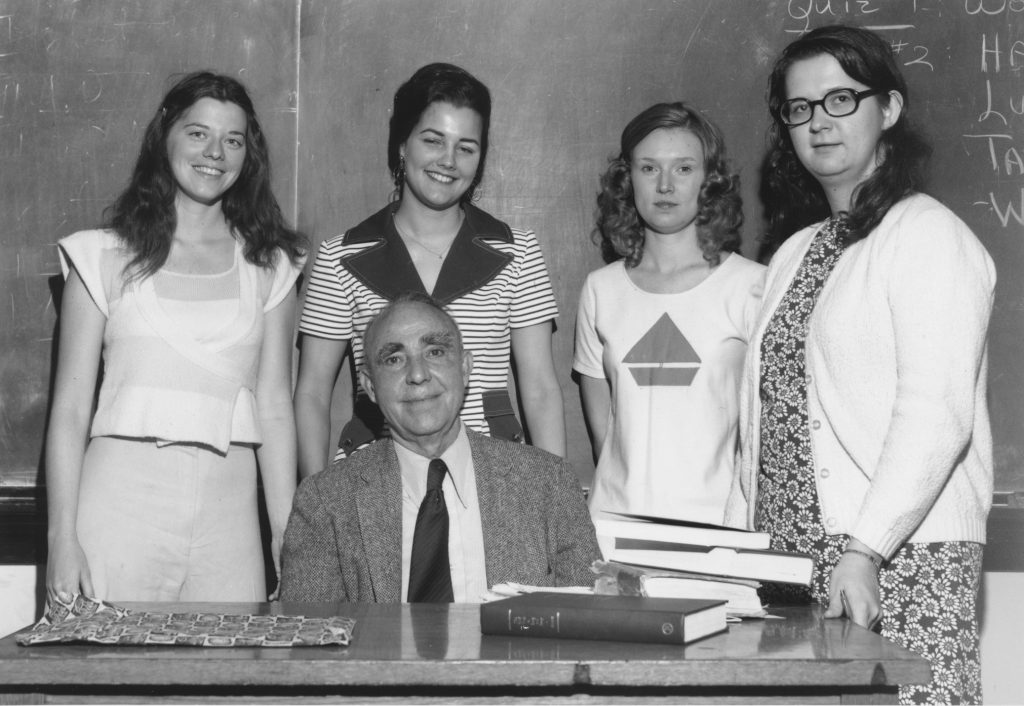 Historic photo of Kenan History Professor Emeritus Hugh Lefler with female students.