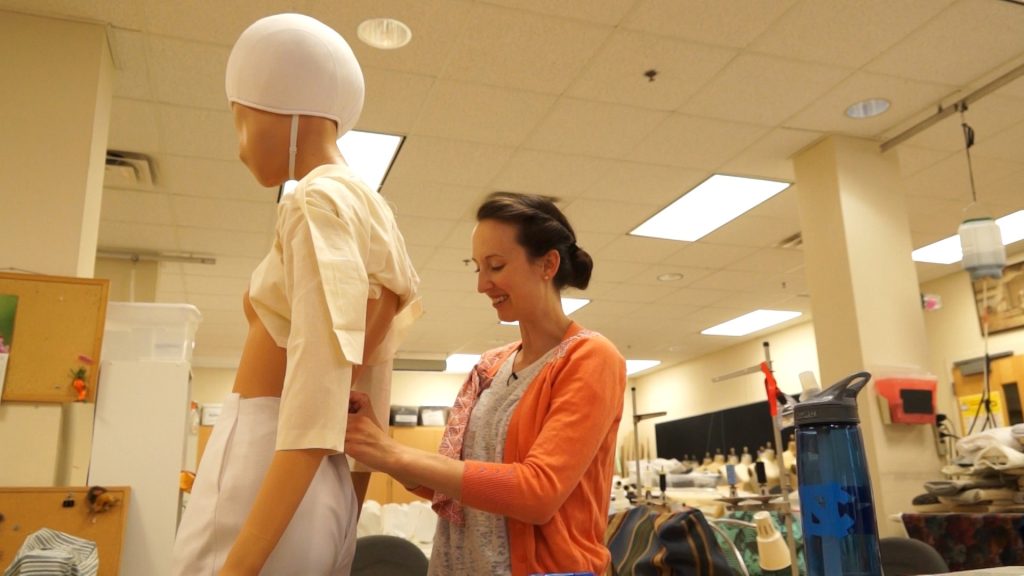 Denise Chukhina works on a costume on a mannequin