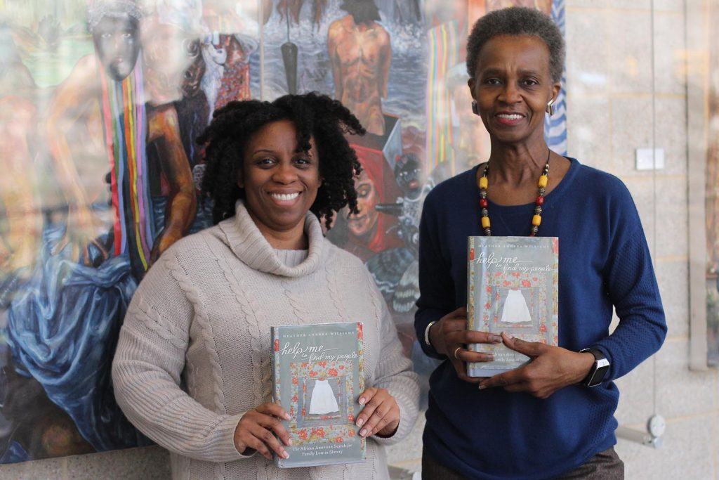 Tanya Shields and Kathy Perkins hold copies of "Help Me to Find My People"