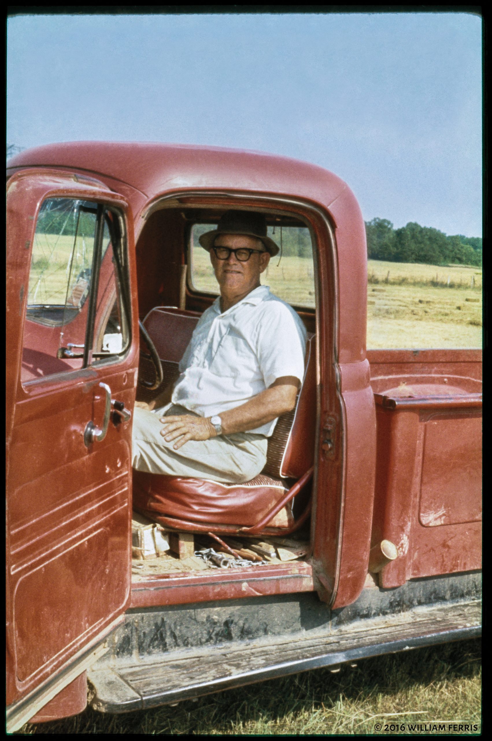 William Ferris S. sits in a red truck