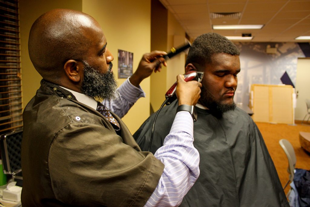 Barber Brian Toulan gives Langden Ramseur a haircut