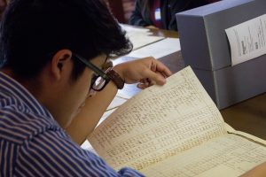 Adonis Tello-Chavez looks at old records in Wilson Library