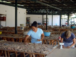 UNC classical archaeology graduate students Sheri Pak (left) and Melissa Eaby (Ph.D. classical archaeology ’07) examine pottery at the INSTAP Study Center for East Crete.