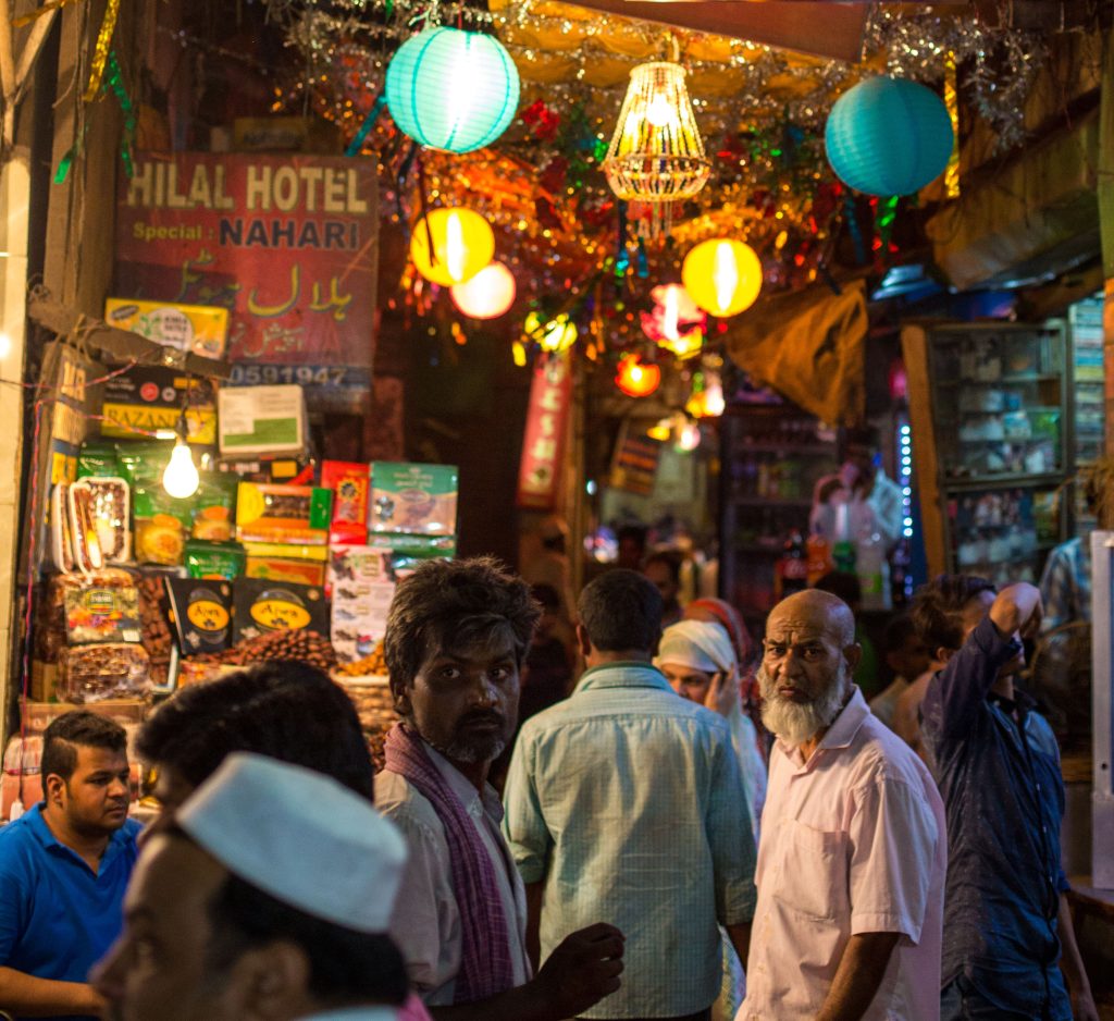 Vendors and shoppers at a night market behind the Jama Masjid mosque in Delhi, India. 