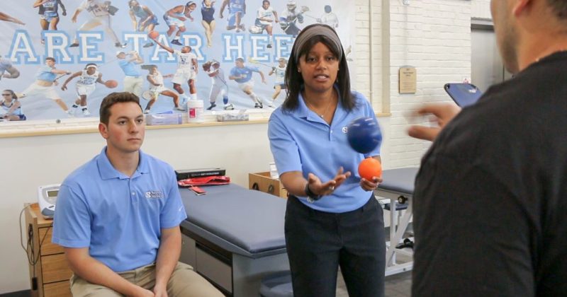 Gfeller Center researchers practice active rehab strategies with a patient, tossing balls back and forth