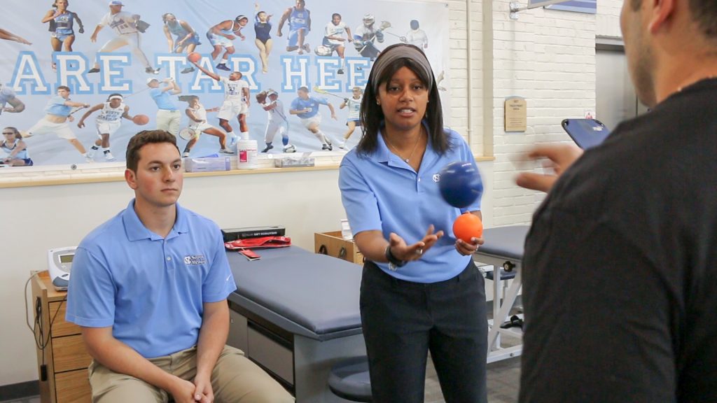 Gfeller Center researchers practice active rehab strategies with a patient, tossing balls back and forth