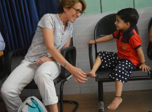 On a visit to northern India, Chesca Colloredo-Mansfeld plays with a patient waiting for his appointment at a partner clinic.