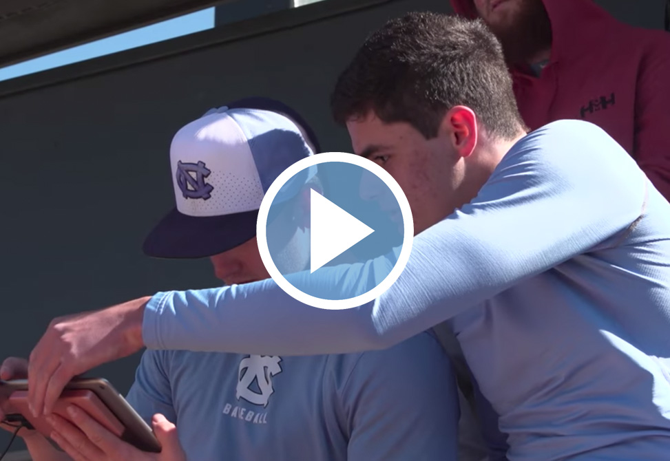 Micah Daley-Harris helps a baseball player analyze his stats.