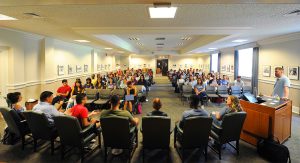 Students and faculty gathered in one large room