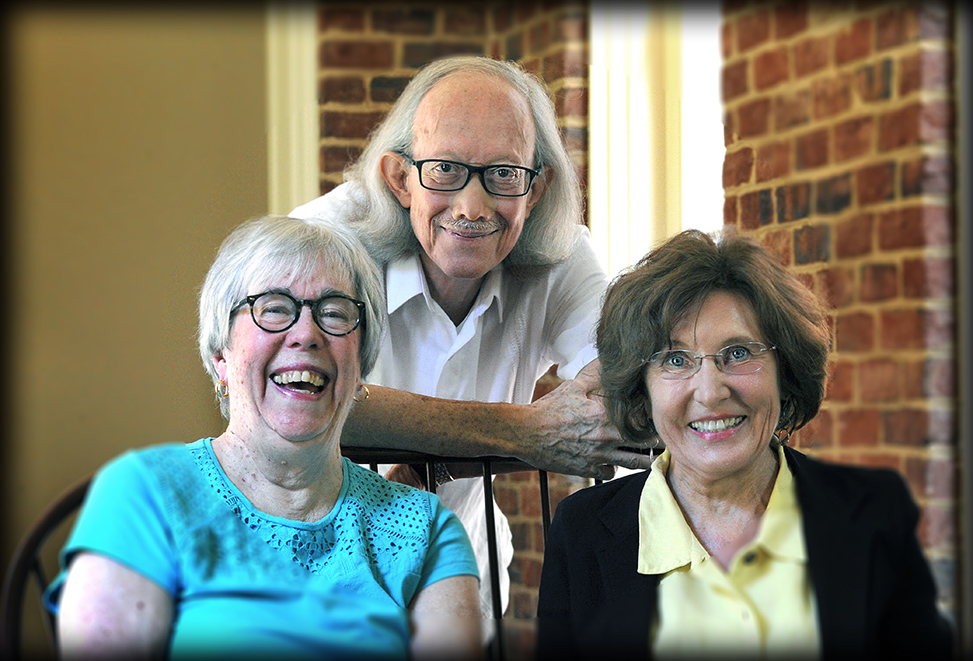 From left, retired faculty members Jean DeSaix, Arturo Escobar and Jacquelyn Dowd Hall share a laugh in Hyde Hall, home of the Institute for the Arts and Humanities.