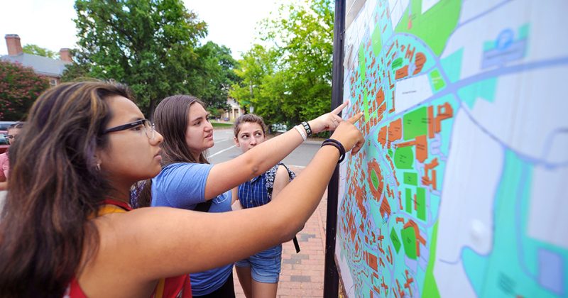 Lookout Scholars Briyete Garcia-Diaz, Sara Coello and Hannah Thompson examine a campus map during an orientation scavenger hunt.