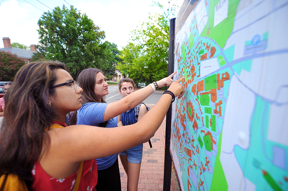 Lookout Scholars Briyete Garcia-Diaz, Sara Coello and Hannah Thompson examine a campus map during an orientation scavenger hunt.