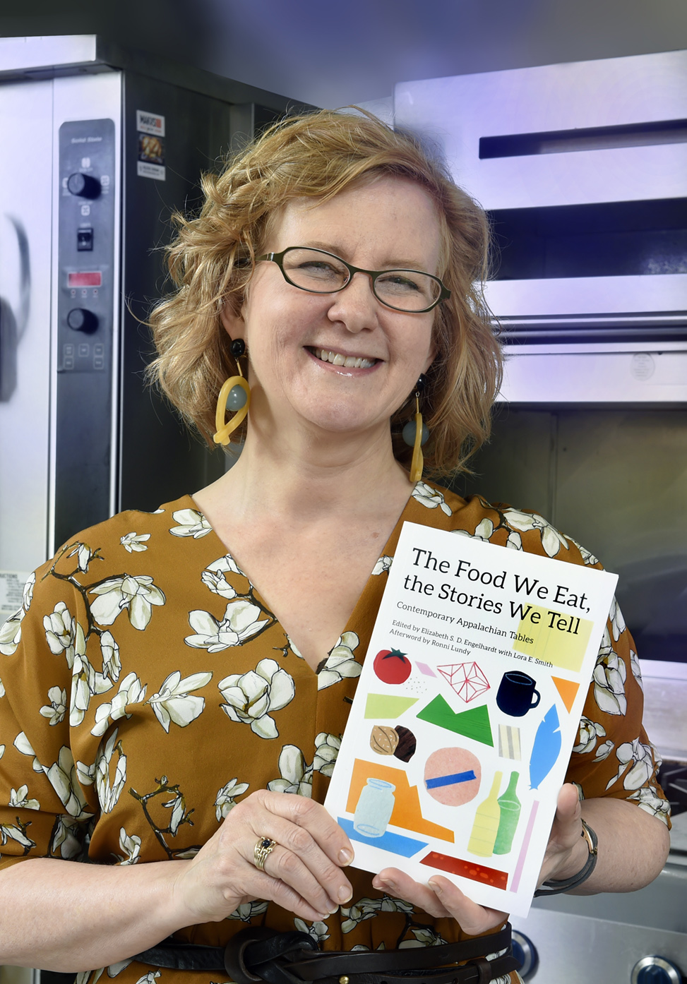 Elizabeth Engelhardt poses with her book, 'The Food We Eat, the Stories We Tell.'