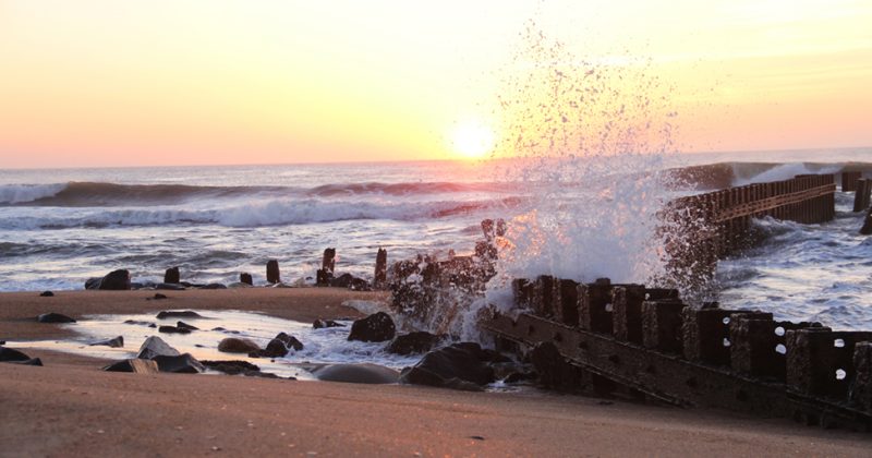Waves crash against a barrier on the Outer Banks.