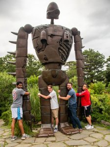 Michael Sparks and friends hug a giant sculpture at the Ghibli Museum in Tokyo.
