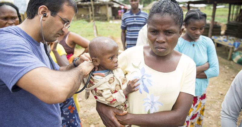 Raj Panjabi pictured assisting a malnourished child.