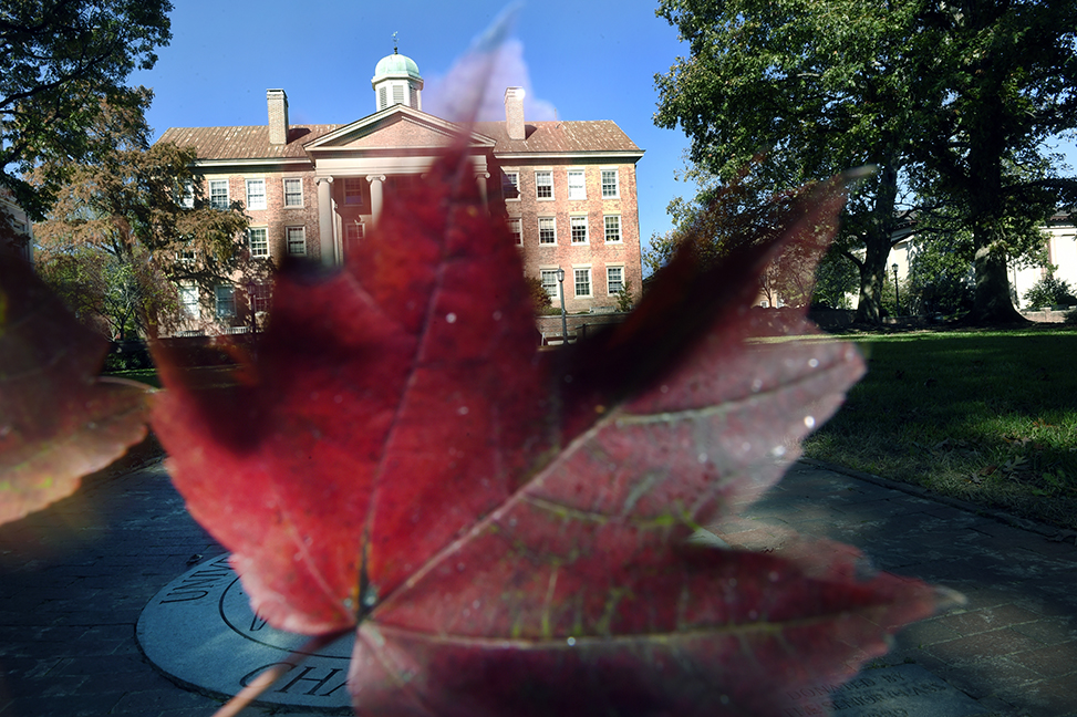 A photo of a fall leaf in front of the South Building on UNC-Chapel Hill