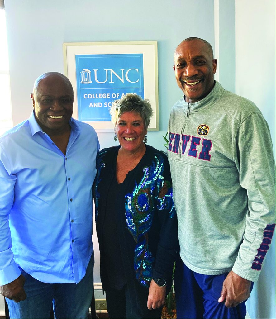 Dean Terry Rhodes with two former UNC basketball players.