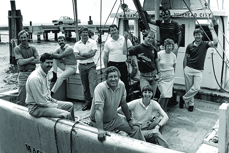 An old black & white photo of IMS researchers on a boat in Morehead City