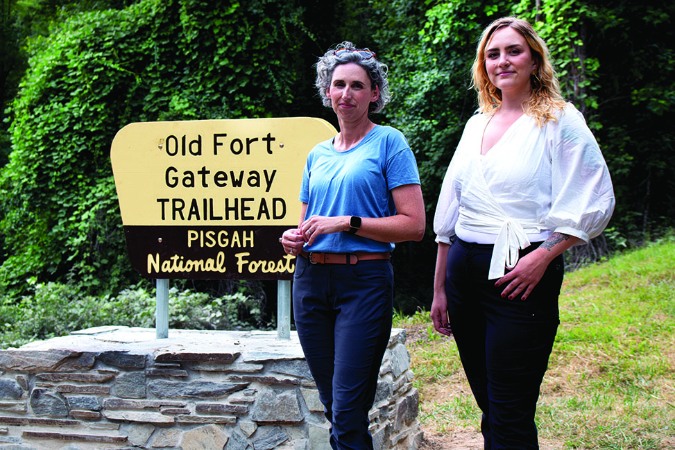 From left, Jennifer Gates-Foster and Cayla Colclasure stand at the Old Fort Gateway Trailhead sign.