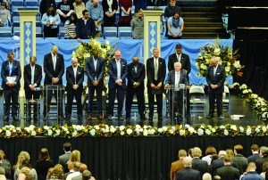People stand on stage at Dean Smith's Memorial Service.