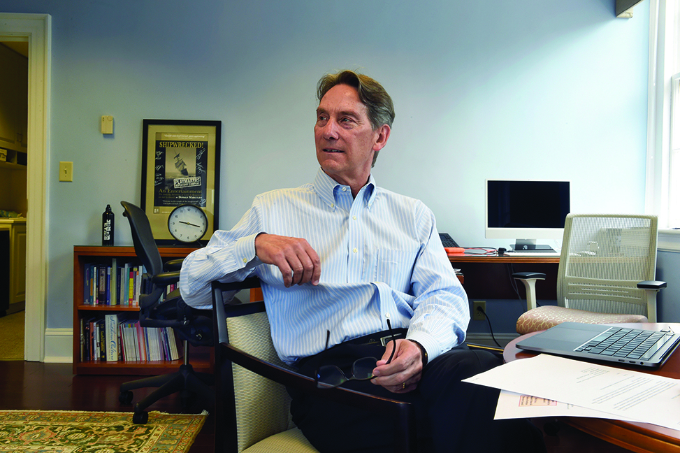 Dean Jim White sits at his desk in South Building.