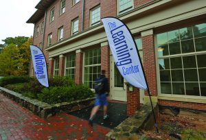 Banners saying "Writing Center" and "Learning Center" hang outside the current building housing the center.