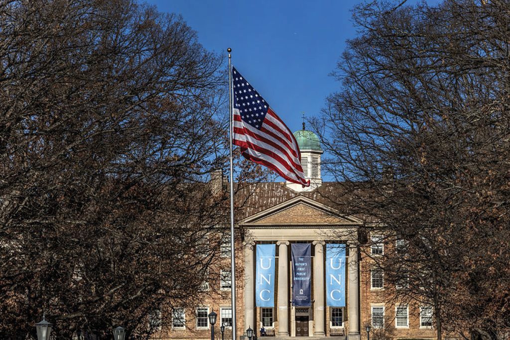 An American flag flies in front of South Building