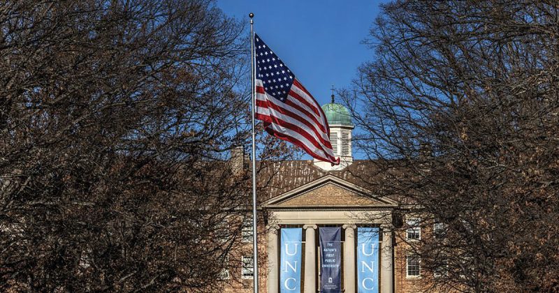 An American flag flies in front of South Building