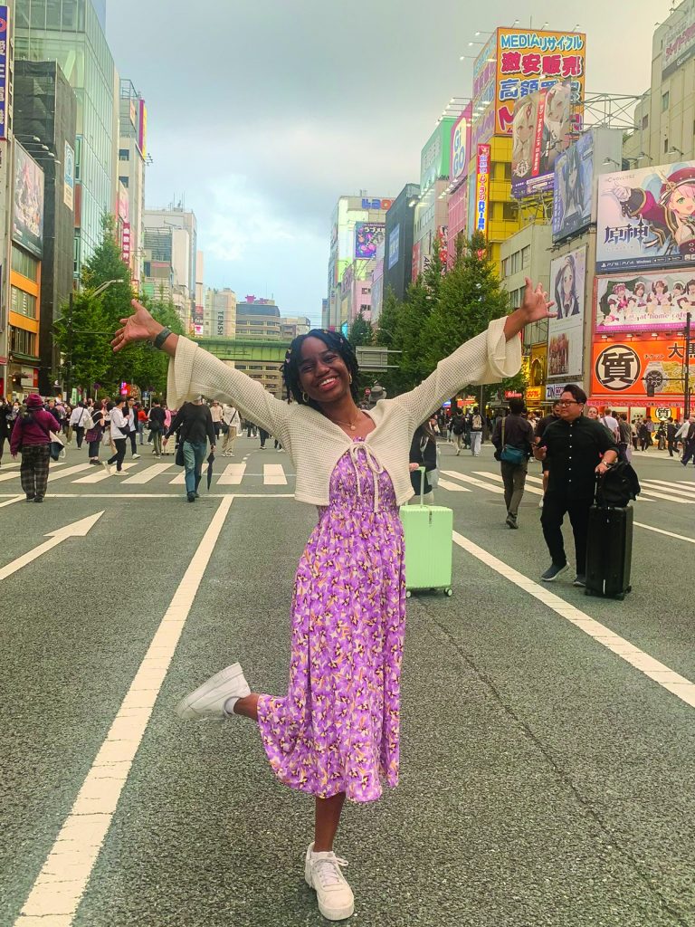 Xenia Weakly strikes a pose in the middle of a crowded street in Akihabara, Japan.