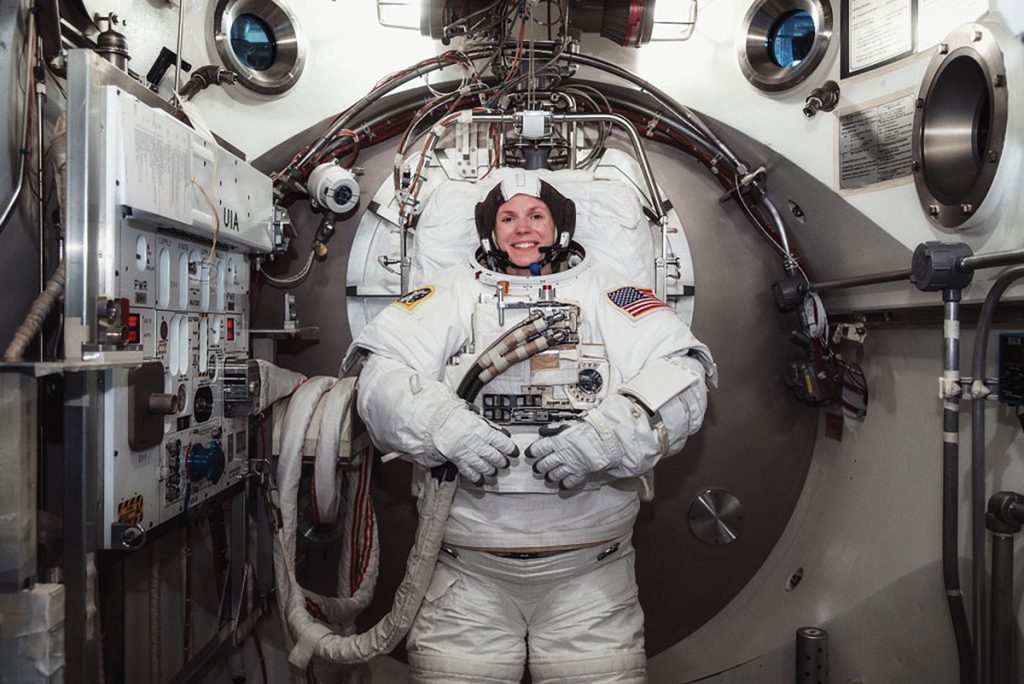 Astronaut Zena Cardman in full gear inside a space shuttle