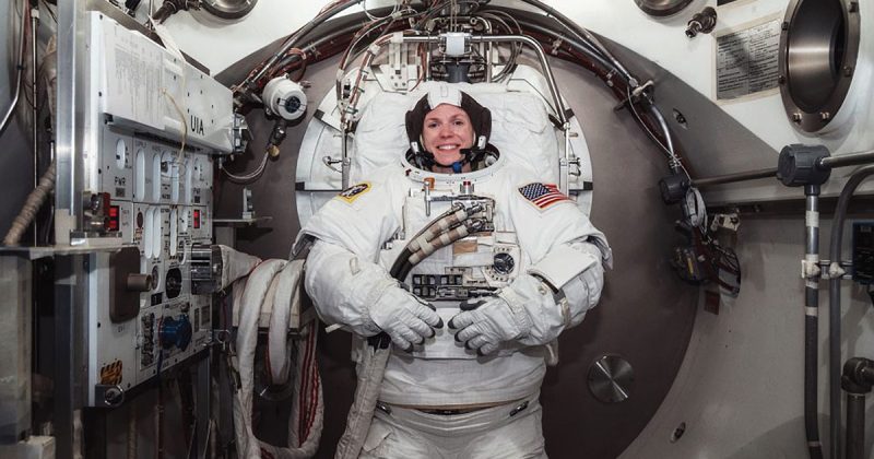 Astronaut Zena Cardman in full gear inside a space shuttle